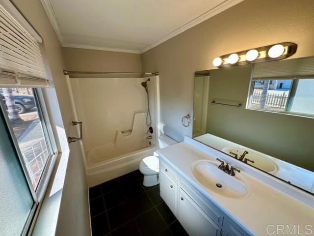 full bathroom featuring vanity, bathing tub / shower combination, crown molding, tile patterned flooring, and toilet