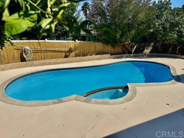 view of pool with an in ground hot tub