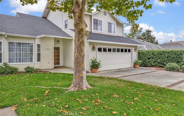 view of property with a front yard and a garage