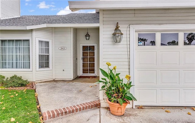 doorway to property featuring a garage