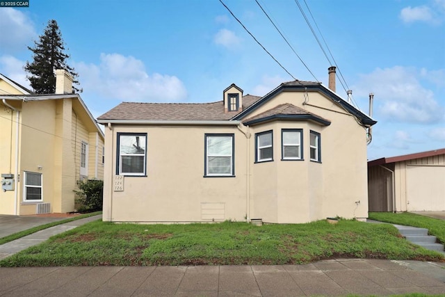 view of property exterior with a yard