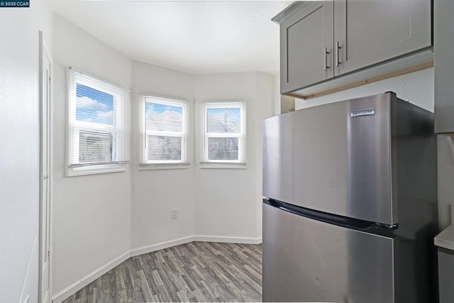 kitchen featuring light hardwood / wood-style flooring, gray cabinets, and stainless steel refrigerator