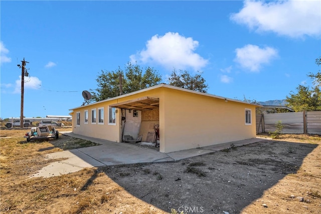 10394 Baker Rd, Lucerne Valley, CA 92356 - view of side of home featuring a patio area