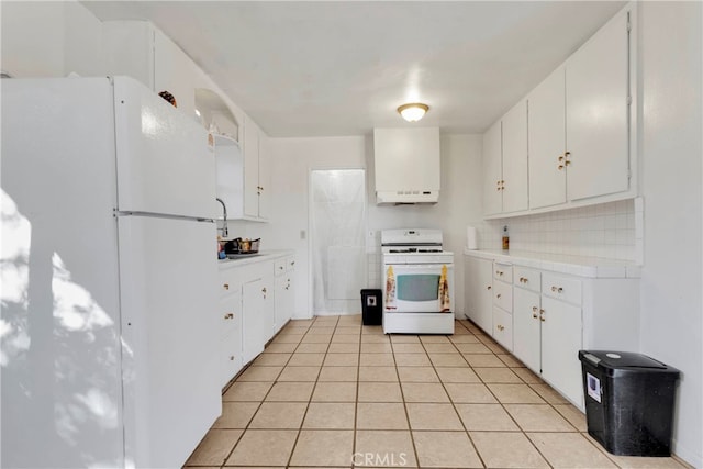 10394 Baker Rd, Lucerne Valley, CA 92356 - kitchen with white appliances, tasteful backsplash, light tile patterned floors, and white cabinets