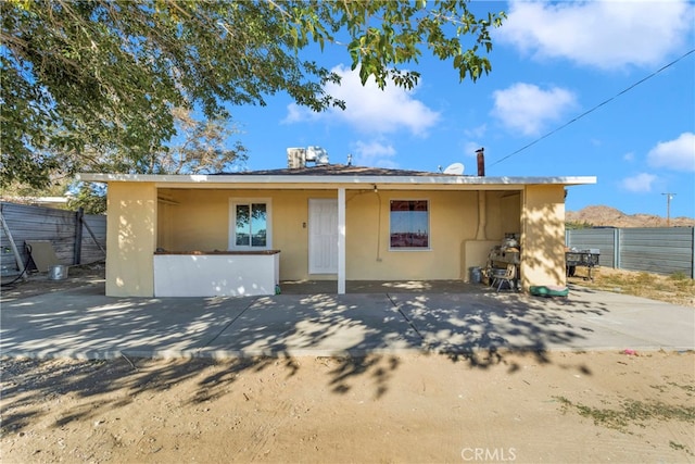 rear view of house featuring a patio