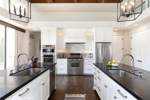 kitchen with dark countertops, stainless steel appliances, and a sink