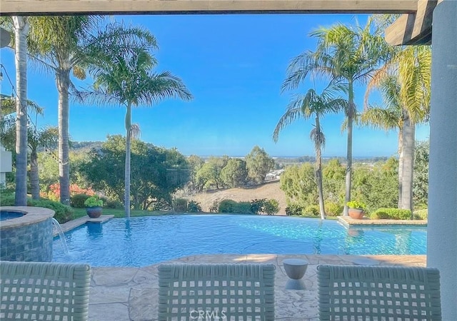 view of swimming pool featuring an infinity pool