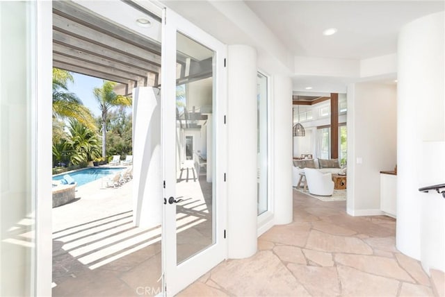 entryway with recessed lighting, stone tile flooring, and french doors