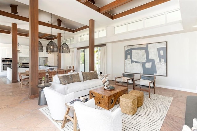 living area with a towering ceiling and baseboards