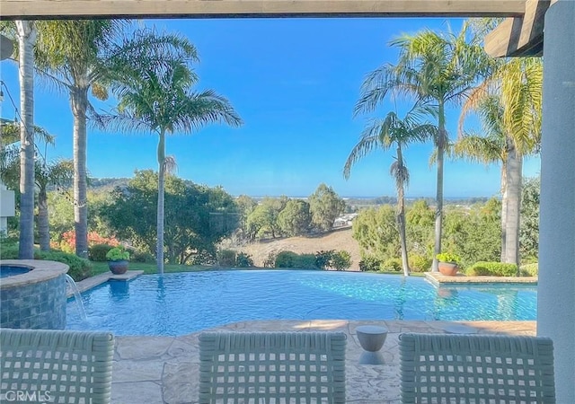 view of swimming pool with an infinity pool