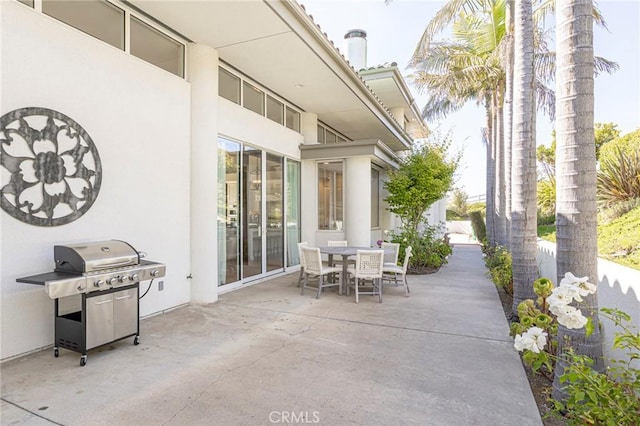 view of patio / terrace featuring outdoor dining space and grilling area