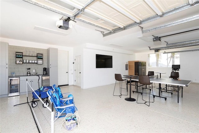 garage featuring wine cooler and a garage door opener