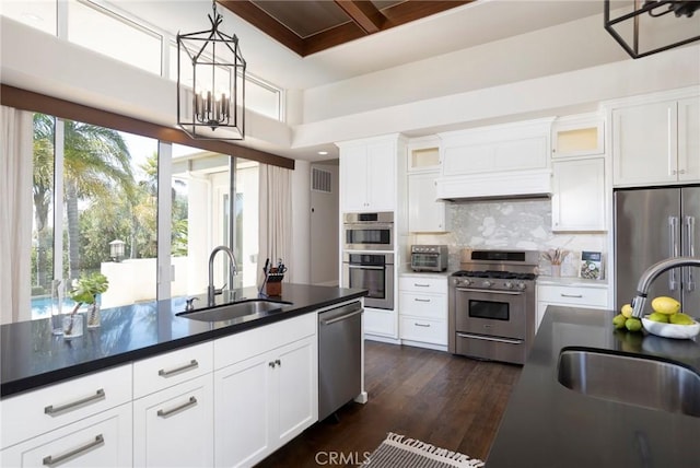 kitchen with stainless steel appliances, visible vents, a sink, and custom exhaust hood