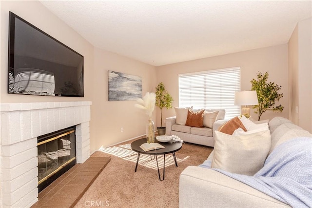 carpeted living room with a brick fireplace