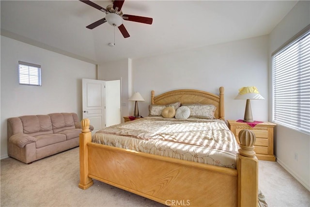 carpeted bedroom with vaulted ceiling and ceiling fan