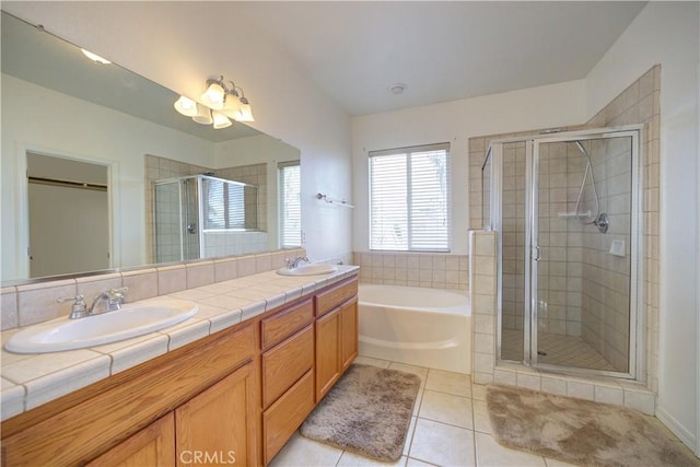 bathroom featuring independent shower and bath, vanity, and tile patterned floors