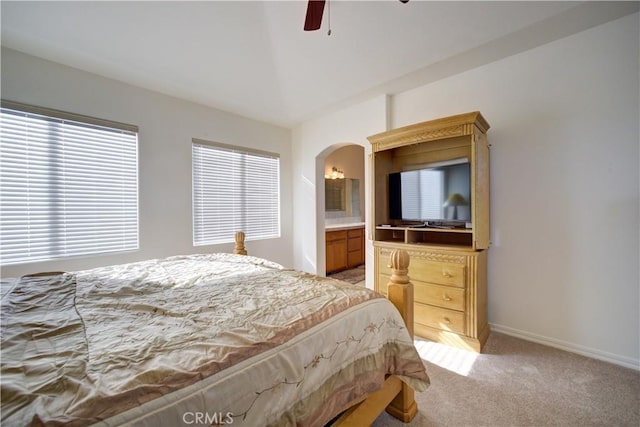 carpeted bedroom with ceiling fan and connected bathroom