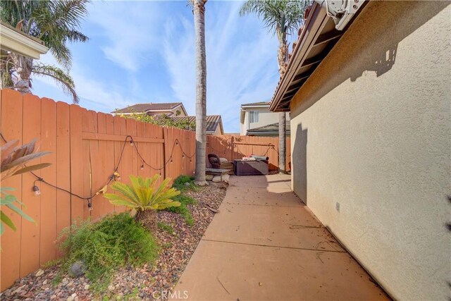 view of side of property with a patio area