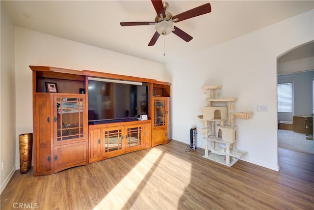 living room with wood-type flooring and ceiling fan