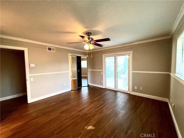 spare room with dark hardwood / wood-style floors, ceiling fan, ornamental molding, and a textured ceiling