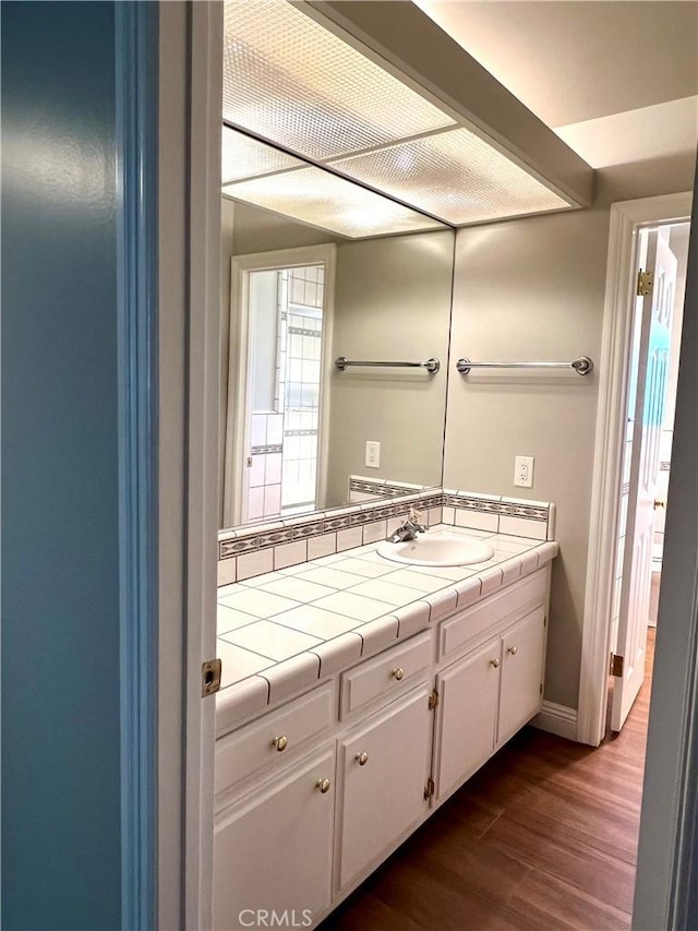 bathroom with hardwood / wood-style floors and vanity