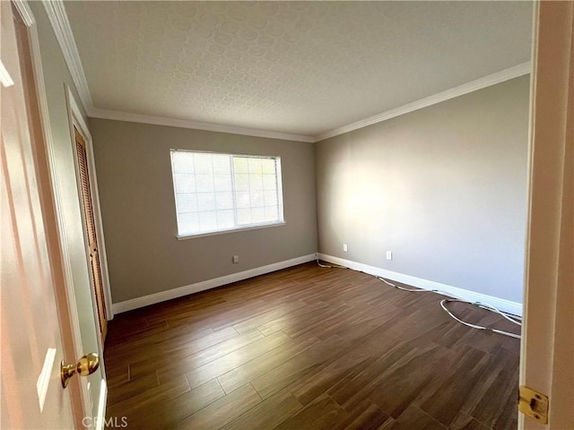 empty room with ornamental molding, a textured ceiling, and dark wood-type flooring