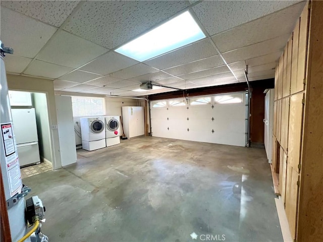 garage with washer and clothes dryer, refrigerator, and a garage door opener