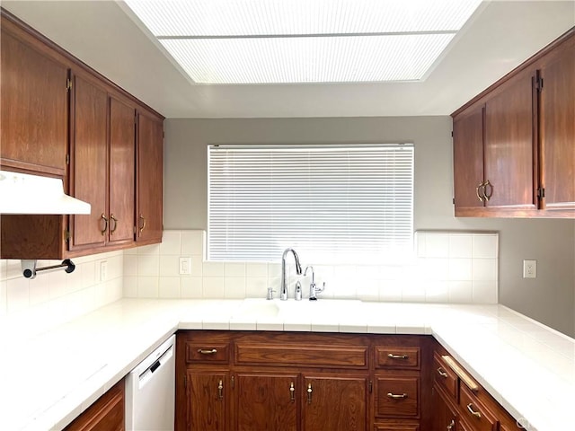 kitchen with backsplash, dishwasher, and sink