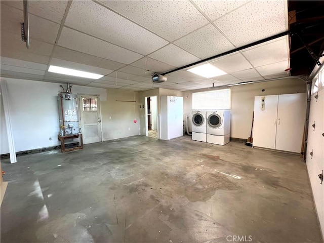 garage with secured water heater, separate washer and dryer, and a garage door opener