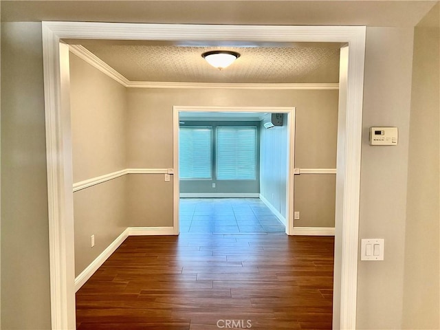 hall featuring dark hardwood / wood-style floors, a wall mounted AC, and crown molding