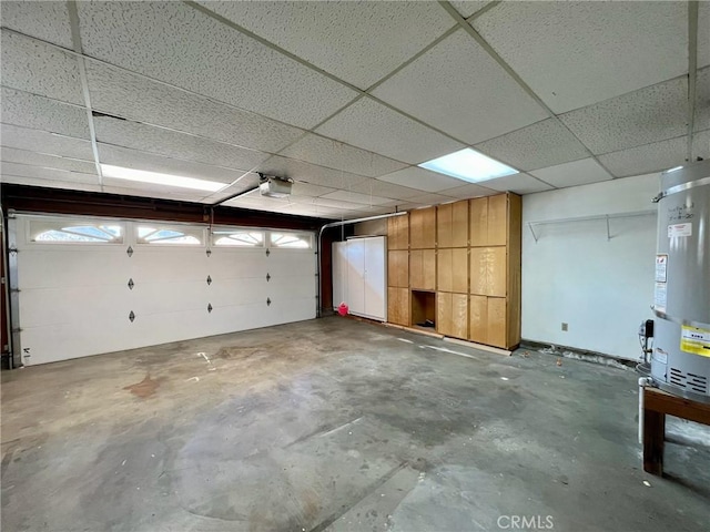 garage featuring strapped water heater and a garage door opener