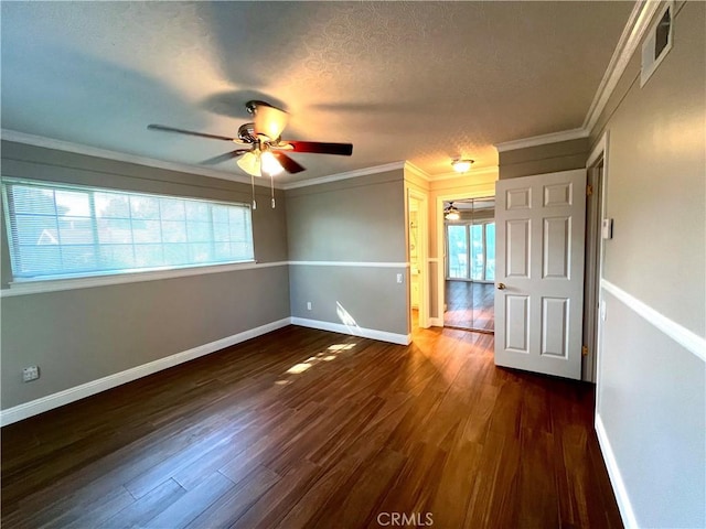 spare room with a textured ceiling, ceiling fan, dark hardwood / wood-style flooring, and crown molding