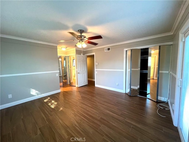 unfurnished bedroom featuring ceiling fan, dark wood-type flooring, and ornamental molding