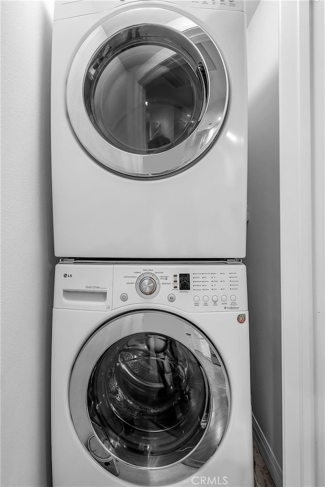 laundry room with stacked washer and clothes dryer