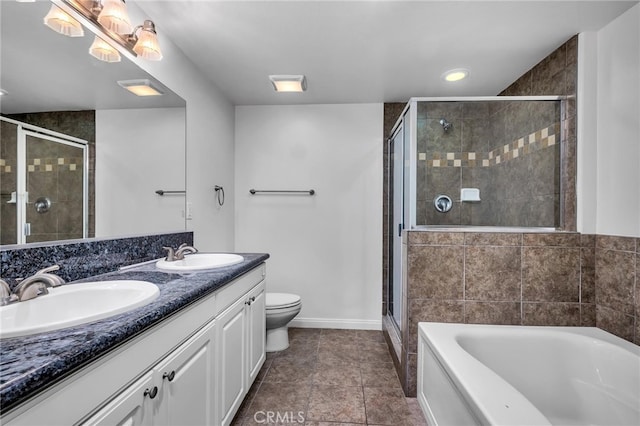 full bathroom with vanity, shower with separate bathtub, and toilet