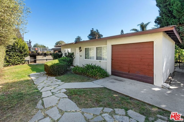 view of front of home with a front yard and a garage