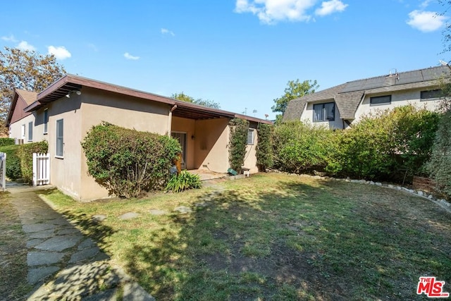 rear view of property featuring a yard