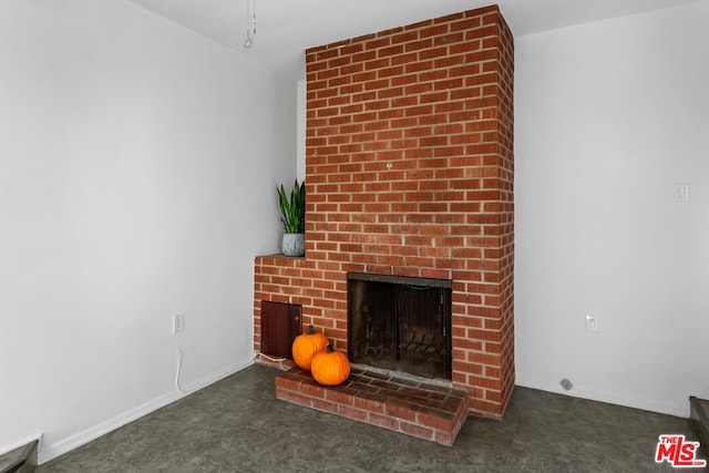 unfurnished living room with a brick fireplace