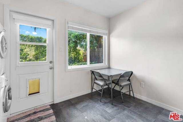 dining space featuring stacked washer and clothes dryer