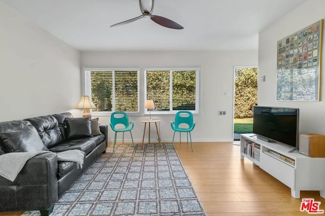 living room featuring hardwood / wood-style flooring and ceiling fan