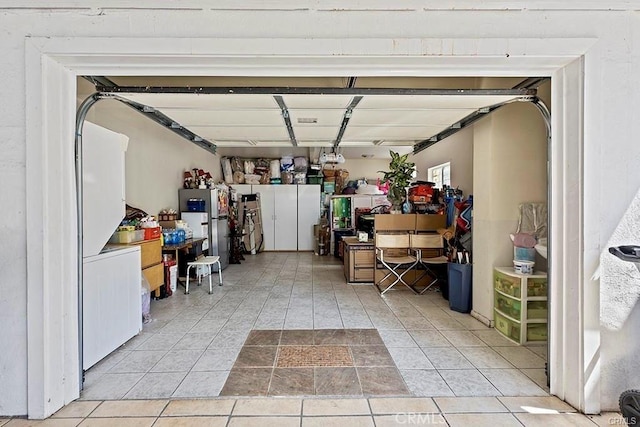 garage featuring stainless steel refrigerator