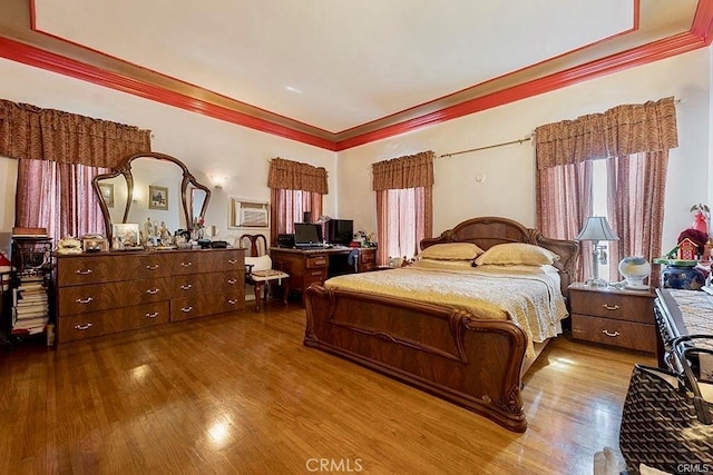 bedroom with wood-type flooring and crown molding