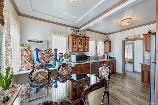 kitchen featuring a wall mounted air conditioner, appliances with stainless steel finishes, crown molding, sink, and light hardwood / wood-style flooring