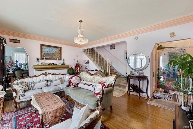 living room featuring hardwood / wood-style flooring, crown molding, and a chandelier