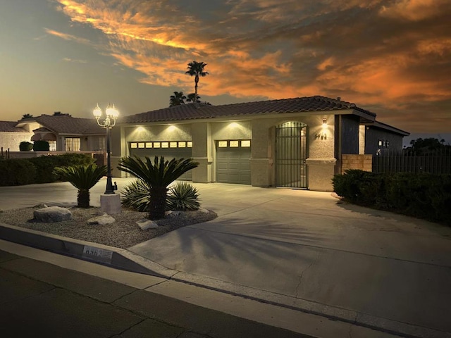 mediterranean / spanish home featuring a garage