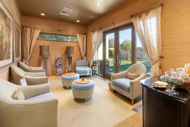 living area with wood walls and french doors