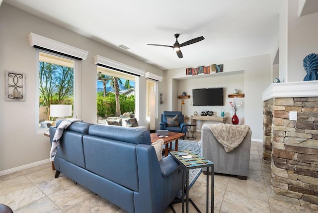 living room with ceiling fan and an AC wall unit