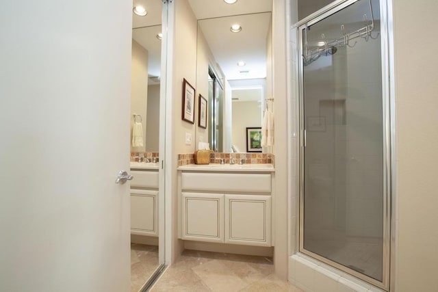 bathroom with tile patterned floors, vanity, and walk in shower