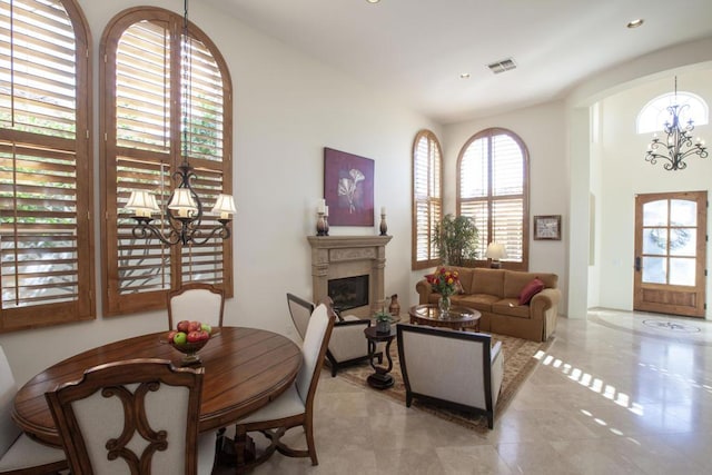 dining room with light tile patterned flooring and a chandelier