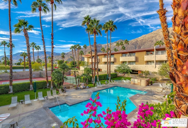 view of pool featuring a mountain view and a patio